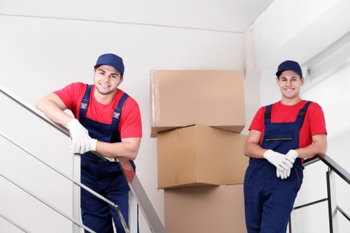 Professional movers carrying furniture in a Tooting property