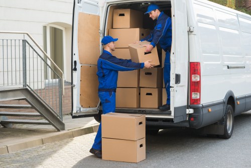 Staff assessing a removal job and handling items with care