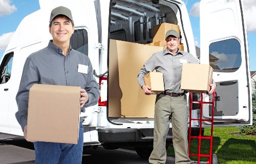 Staff using safe lifting techniques during a house move
