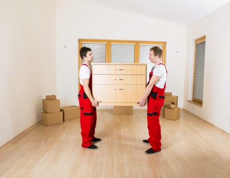 Professional movers handling office equipment during commercial moves in Tooting